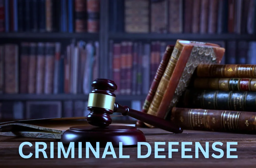 Criminal defense, featuring a gavel, handcuffs, and legal documents on a desk