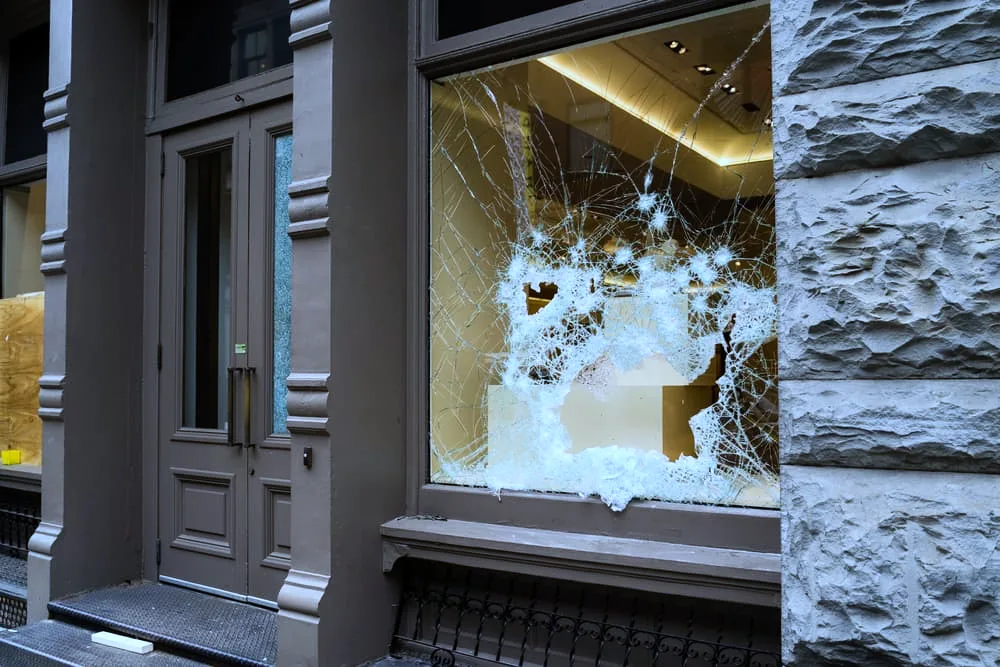 Broken store window by vandals