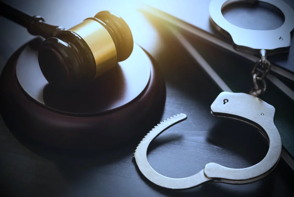 Handcuffs and wooden gavel. Crime and violence